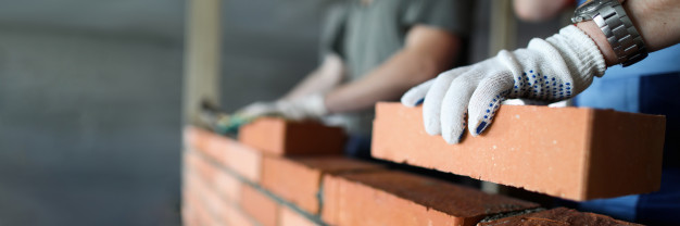 two workers making red brick wall construction site close up 151013 6790