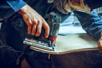 carpenter using circular saw cutting wooden boards 155003 26562