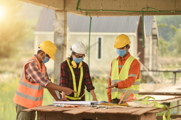 female inspectors architects discuss with head engineer about construction project multi ethnic group engineers meeting construction site eveing time 180392 133