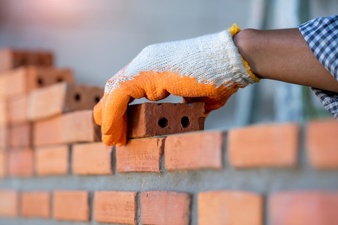professional worker building brick walls with cement 64073 813