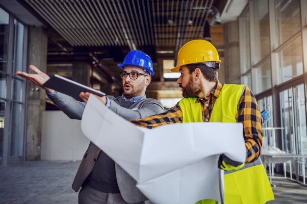 upset architect arguing with construction worker showing him his mistake worker holding blueprints defending himself building construction process interior 232070 7306