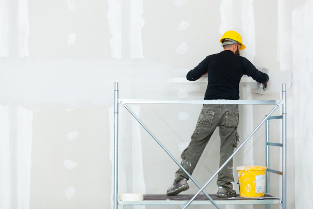 worker plastering gypsum board wall 87414 3761
